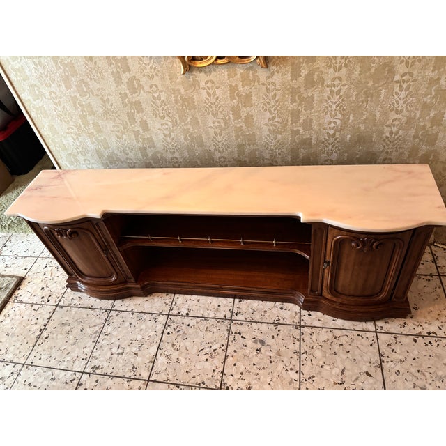 This is a low-profile, marble top walnut (I think) with brass detail knobs and railing. Neoclassical mid-century revival...