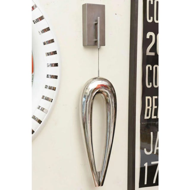 This suspended wall sculpture that is contemporary is by a West Coast sculptor. It is a combination of primitive with the...