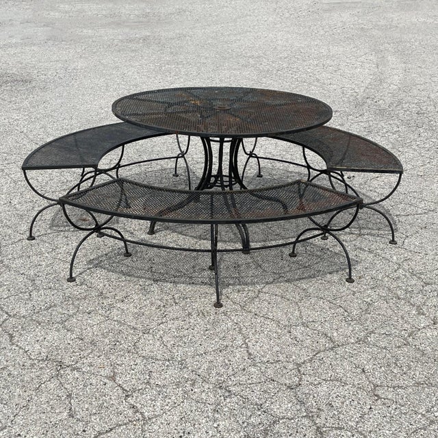 This terrific patio set is an uncommon one by Woodard. Comprised of a four foot table with three curved benches, it is...