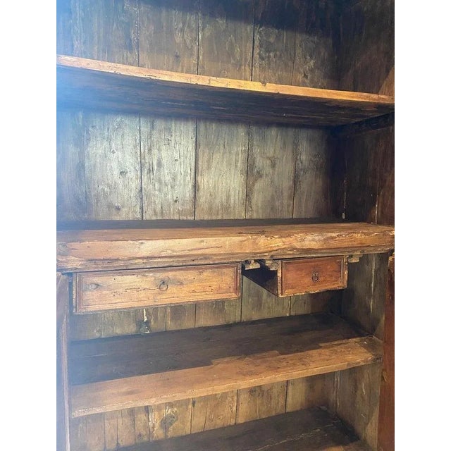 19th century ebonized two-door pine cabinet. Interior has two lower doors concealing two drawers with exposed upper fixed...
