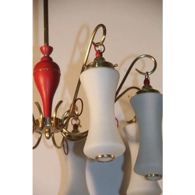 This chandelier was made in Italy during the 1950s and features a brass structure holding eight opaline shades with a...
