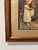 Vintage framed print after Arthur John Elsley’s 1908 painting A Tempting Bait, depicting four children enticing a white...