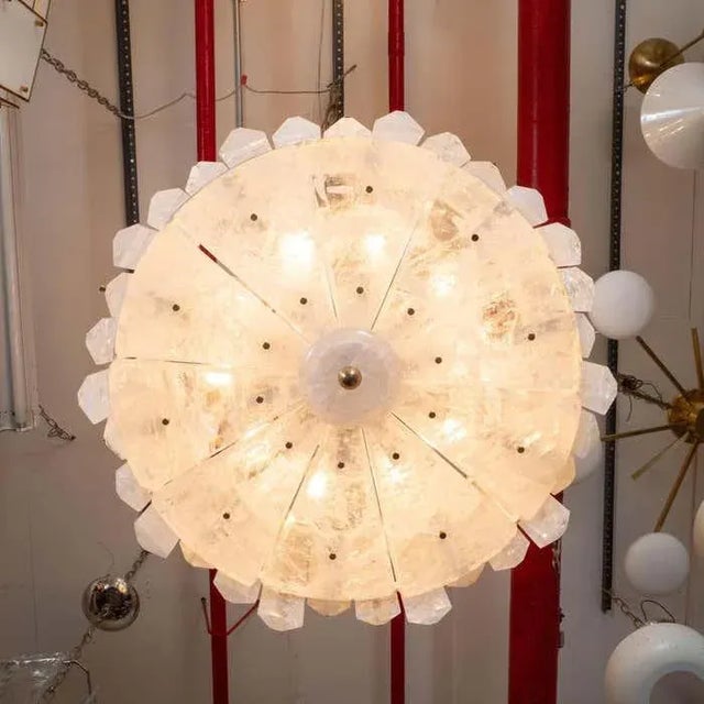 Chandelier featuring hand beveled rectangular quartz elements of varying sizes and bottom diffuser composed of triangular...