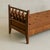A 1950s French daybed in the manner of Jacques Adnet, crafted in warm-toned wood. Its tapered legs and diamond-latticed...