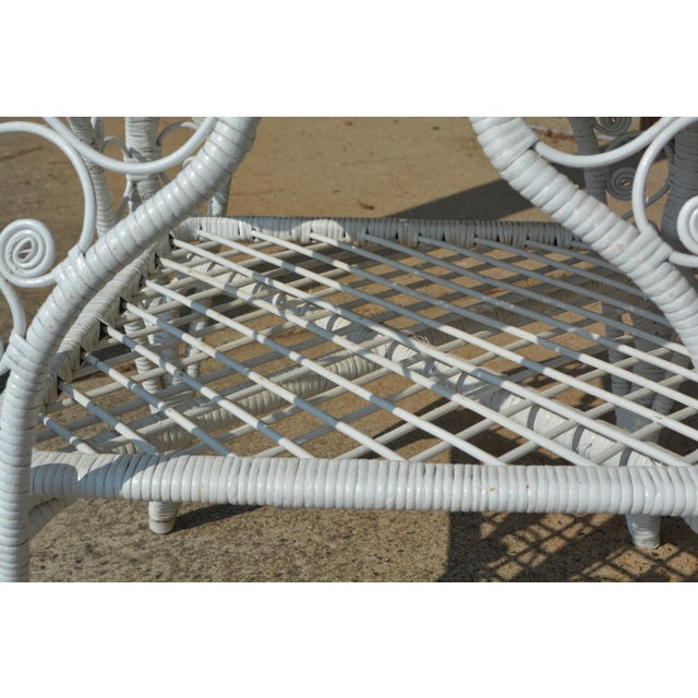 This vintage wicker table is in good condition overall. Pretty fiddlehead design. Lower lattice/criss cross shelf. A piece...