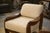 Pair of Brutalist armchairs from the 1970s, with thick, rounded wooden frames. The armrests are sculpted in the shape of...