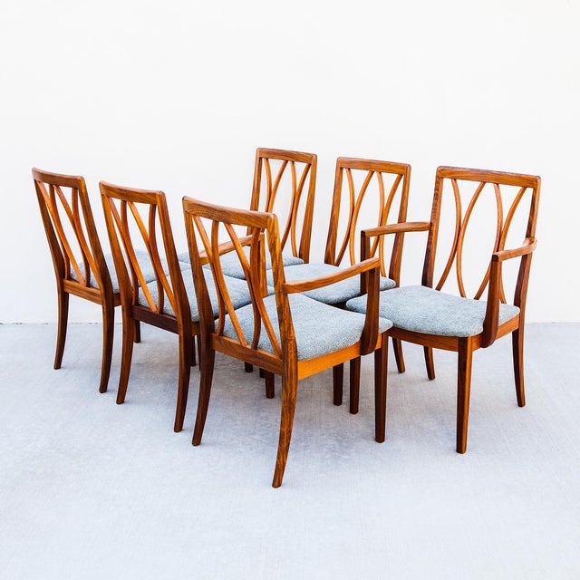 A newly restored set of six British mid century dining chairs by G-Plan, made in England c. 1970s. The chair is defined by...