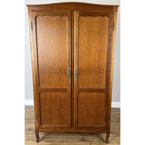 This elegant Vintage French Louis wardrobe showcases refined craftsmanship with a warm oak finish, gently curved panelled...