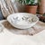 Elevate your dining experience with our Artisan Signed Wheel Thrown Pottery Bowl, featuring a stunning abstract blue hand-...