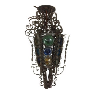 Mediterranean Style Iron Light Fixture With Curly Cues and Colored Glass For Sale