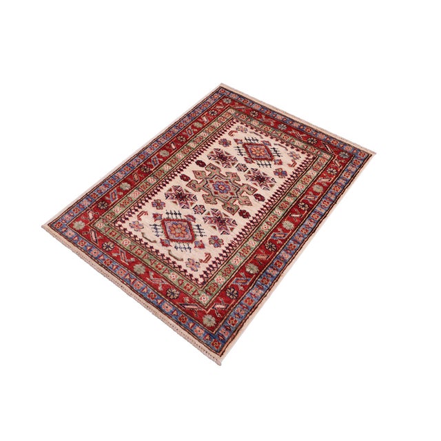Enhance your home with this exquisite hand-knotted Super Kazak rug, crafted from fine hand-spun wool and dyed with all-...