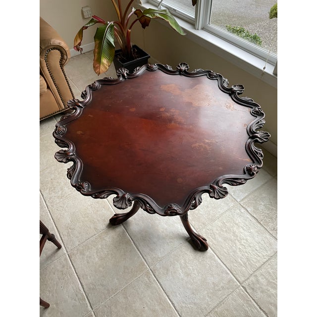 Masterfully carved mahogany tea table. Dining height.