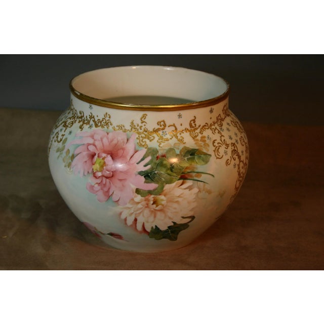 A gorgeous hand painted floral jardiniere by Jean Pouyat Petler (JPL), France. The colors on the flowers are bright and...