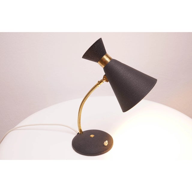 A beautiful classic Mid-Century Modern Table Lamp. The design is minimalist and typical mid-century with a diabolo shade....
