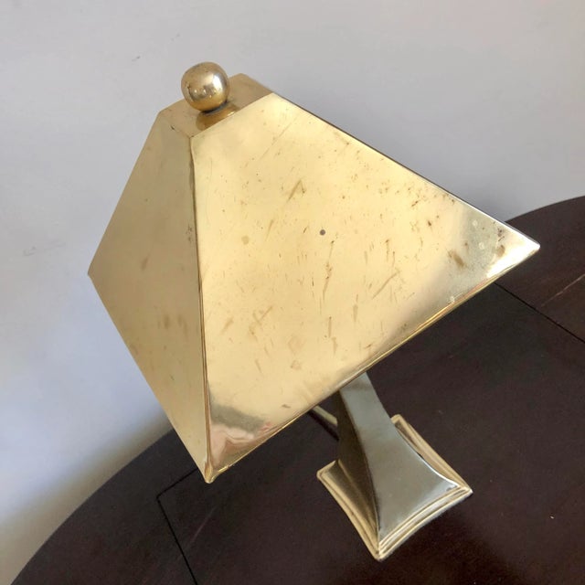 Vintage brass candlestick table lamp with brass pyramid shade.