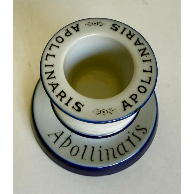 This charming antique porcelain match striker was created as an advertising piece for Apollinaris, the celebrated German...