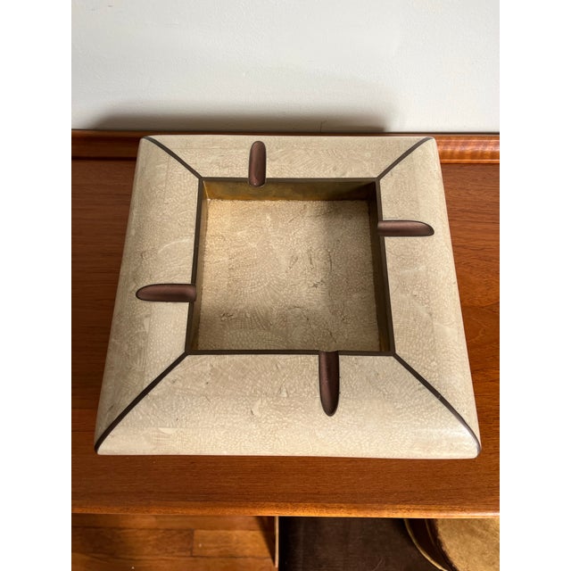 A glamorous vintage Maitland-Smith ashtray featuring hand-applied tessellated stone with contrasting brass trim. Its...