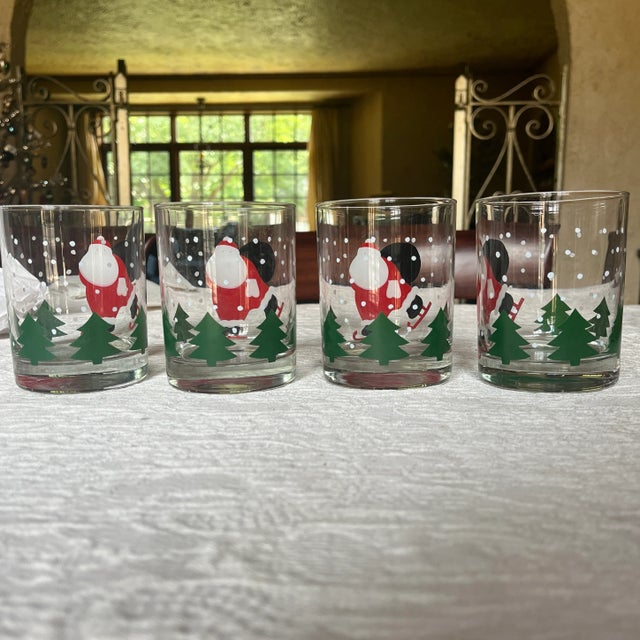 Crate & Barrel Vintage Ice Skating Santa Glass Set of 4. Holds 12 oz. 4 1/8” tall x 3 1/4” These Glasses Have No cracks or...
