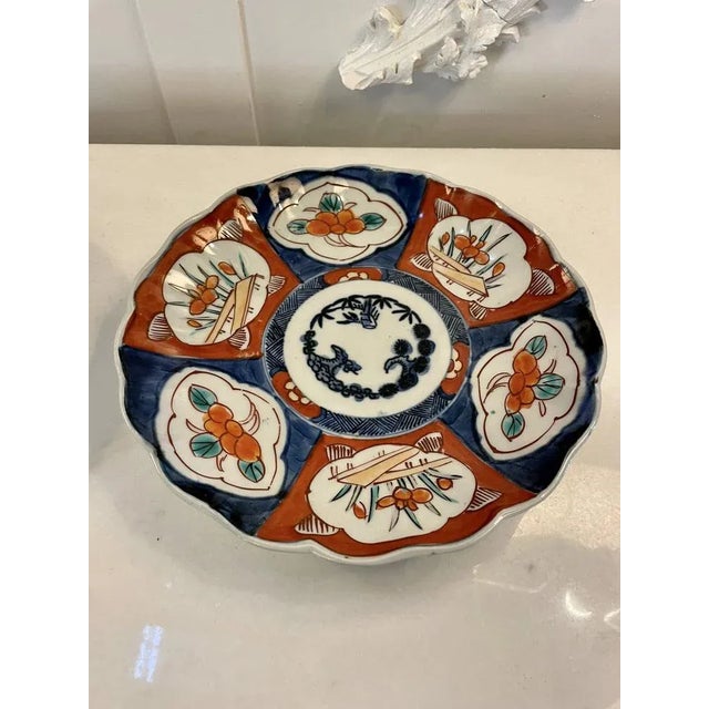 Pair of antique Japanese quality Imari plates having scalloped edges with wonderful hand painted panels in red, blue,...