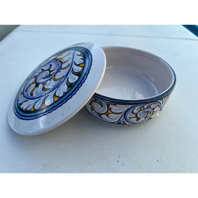 Italian Art Pottery Dipinto A Mano (hand painted ) and glazed Trinket Box. The colors are bright and it is signed on the...