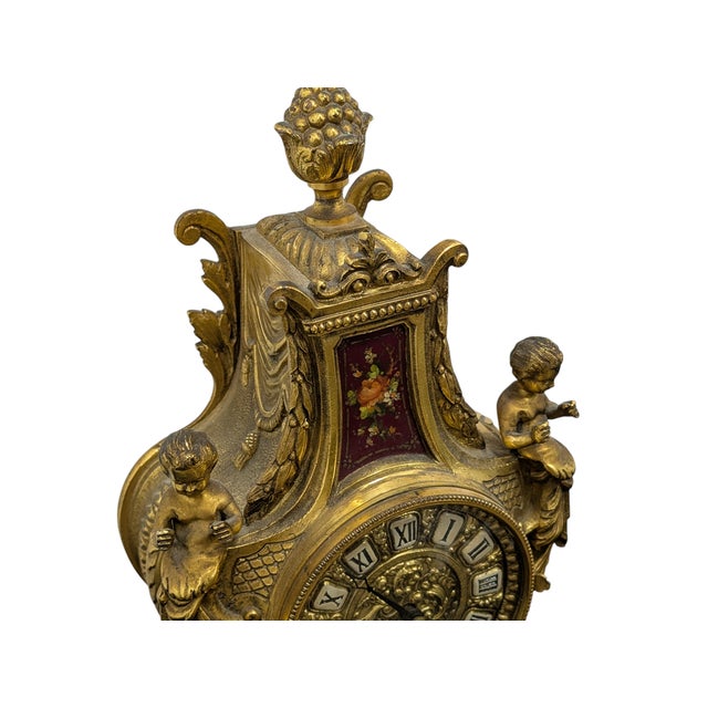 An elegant Louis XV-style table clock, featuring a sumptuous gilded bronze case richly engraved with rocaille motifs,...