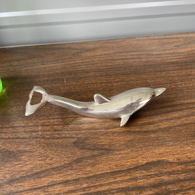 This bottle opener opens two different types of bottles. Made from what appears to be polished chrome. Circa the mid 20th...