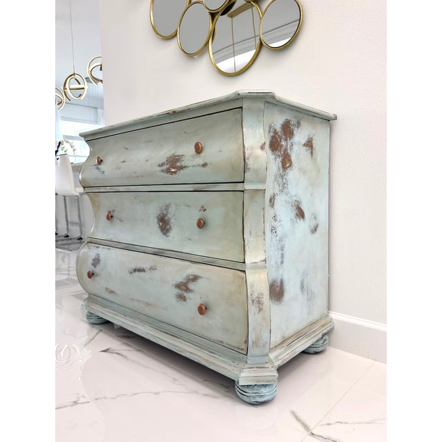A beautifully hand-refinished French-style bombé dresser, reimagined in a soft azure coastal patina by Maison Martine....