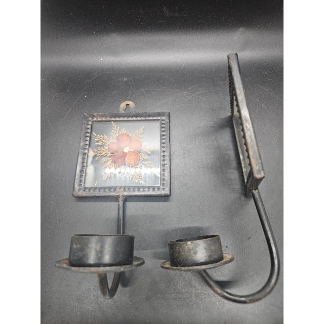 pair of vintage black metal wall candle sconces with dried flower glass inserts