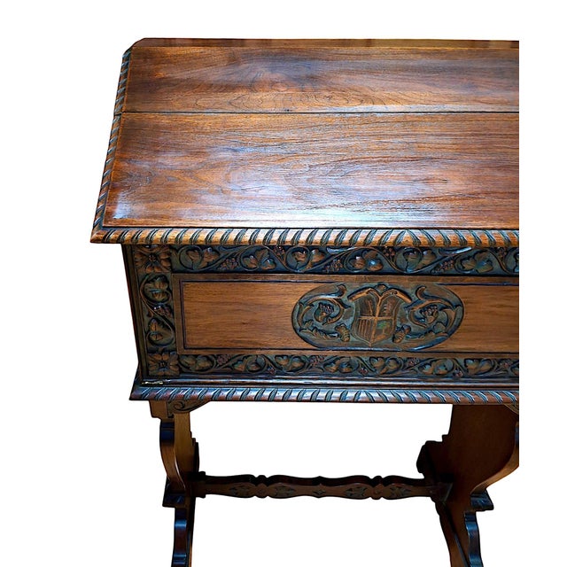 Beautifully carved details in walnut on the exterior, including a raised coat of arms. The hinged lid folds backwards and...