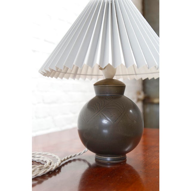 A beautiful spherical ceramic table lamp by Aluminia, Royal Copenhagen. It originally was a vase by Nils Thorsson that had...