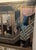 Fine black cabinet with detailed painted chinoiserie scenery. Cabinet sits on brass stand with greek key design. Cabinet...
