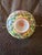 These pieces are small decorative bowls featuring the classic Famille Rose enamel palette with a vibrant yellow background...