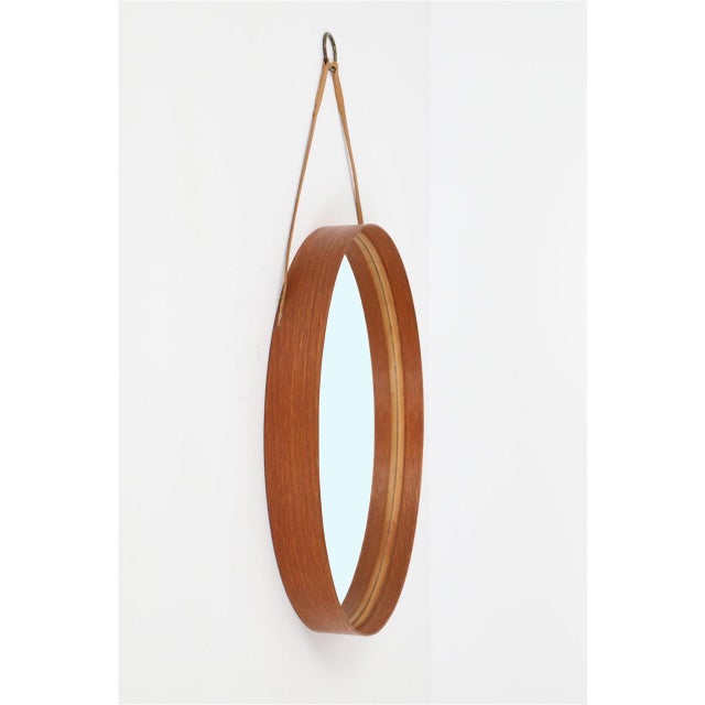 Rare wall mirror by Glas Mäster, Markaryd, Sweden, 1960s/1970s. Model 103, medium size. Teak veneer and suede with brass...