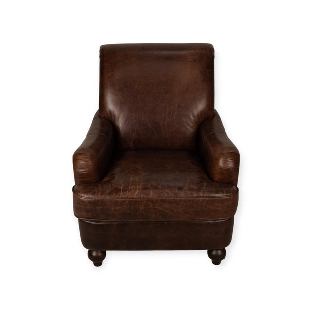 Brown leather club chair by Lazzaro with a tall, gently sloped back, rolled top edge, and low padded arms. Nailhead trim...