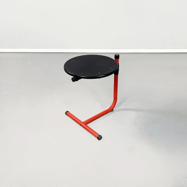 Italian mid-century red metal and black plastic coffee table by Magis, 1980s. Coffee table with round top in black...