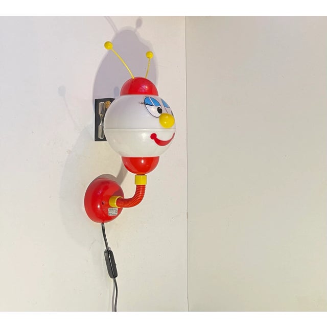 A 1970s adjustable Italian Childs figural wall light. Made by Stilfer Milano circa 1970-75. It is made entirely of plastic...