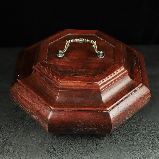 A beautifully crafted Chinese octagonal box, likely made of Huali (rosewood). The piece features a domed, faceted lid...