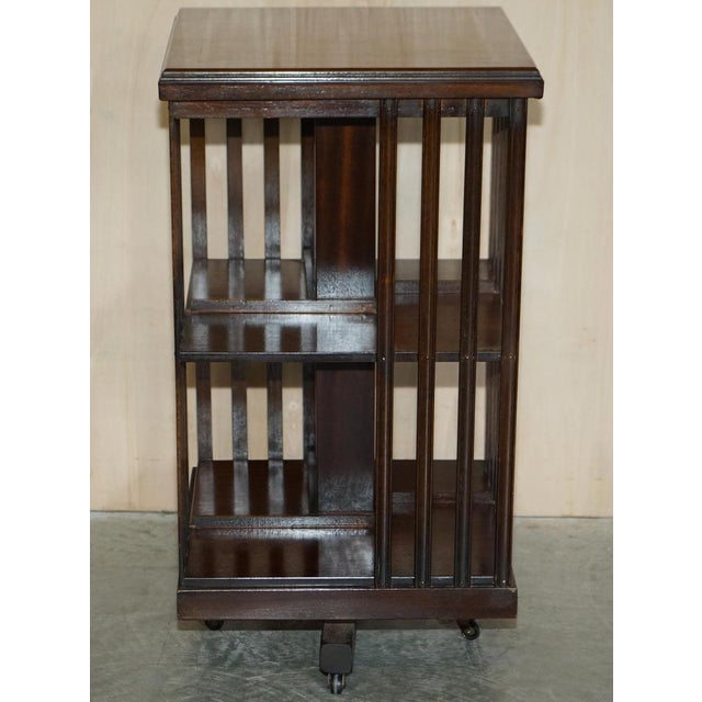 We are delighted to offer for sale this stunning vintage Sheraton Revival Mahogany & Satinwood revolving bookcase table A...