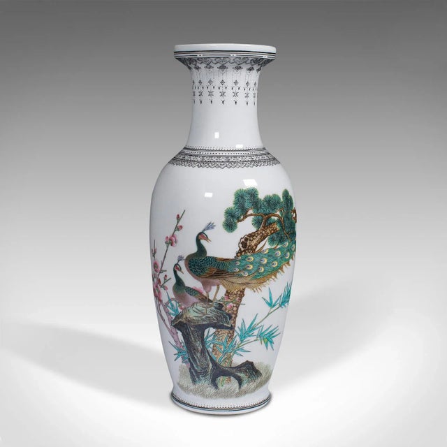 This is a vintage decorative posy vase. A Chinese, ceramic flower urn with peacock decor, dating to the mid 20th century,...