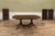An exclusive double pedestal mahogany dining room table made by AntiquePurveyor for seating up to 14 people. It has an...