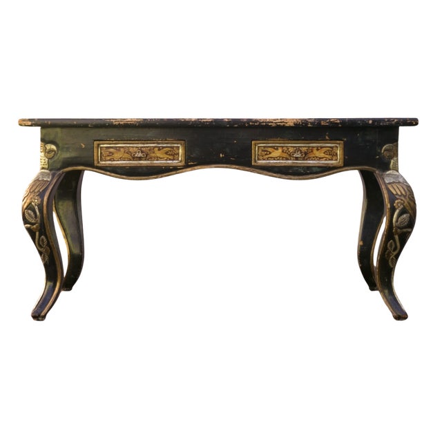 An utterly unique painted, carved, and parcel-gilt writing desk with a commanding presence and a surface no reproduction...