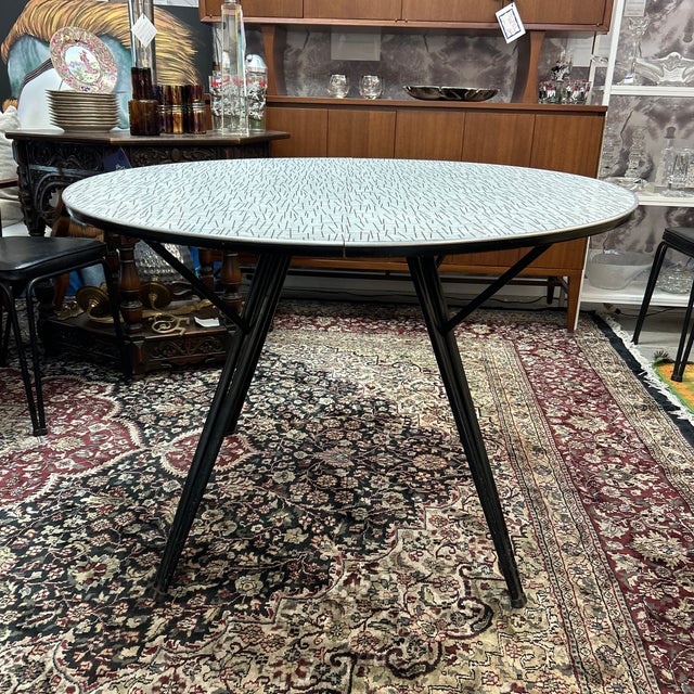 Great period piece from the 1950s. It has a geometric formica top and comes with leaf which when inserted makes the table...