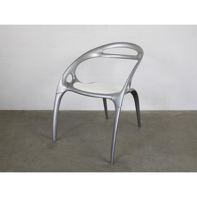 Silver powder coated magnesium frame, White polypropylene seat. This piece has an attribution mark, I am sure that it is...