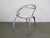 Silver powder coated magnesium frame, White polypropylene seat. This piece has an attribution mark, I am sure that it is...