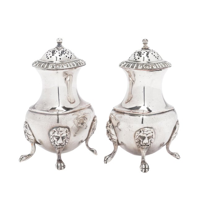 A pair of Barker-Ellis Silver Company pear-shaped pepper castors in Birmingham electroplate. Gadrooned rims frame the...