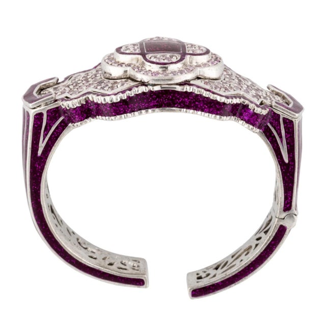 This statement cuff is hand-set with shimmering pink sapphires in an art deco design - the gemstones are meant to...