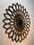 A beautiful decorative fornasetti style weathered metal star-burst with center circular mirror wall hanging, offering...