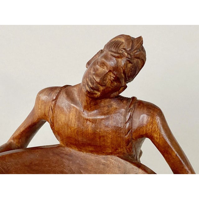 The artist who rendered this artfully carved wooden ashtray certainly has shown empathy toward his subject. The woman’s...