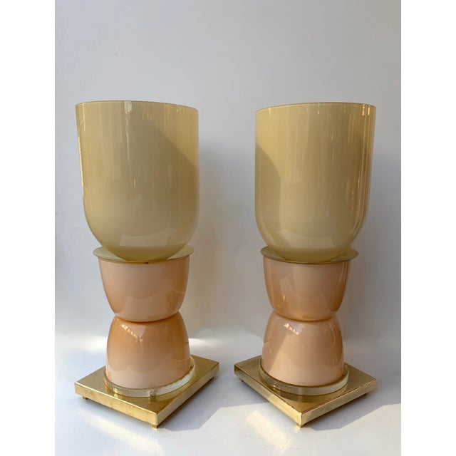 Pair of table or bedside lamps in brass, light pink powder murano glass with murano glass globe shades. Contemporary work...