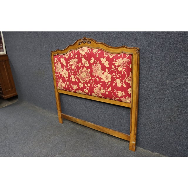 French country style queen headboard crafted in cherry with a shaped crest rail and carved floral ornament at the center....